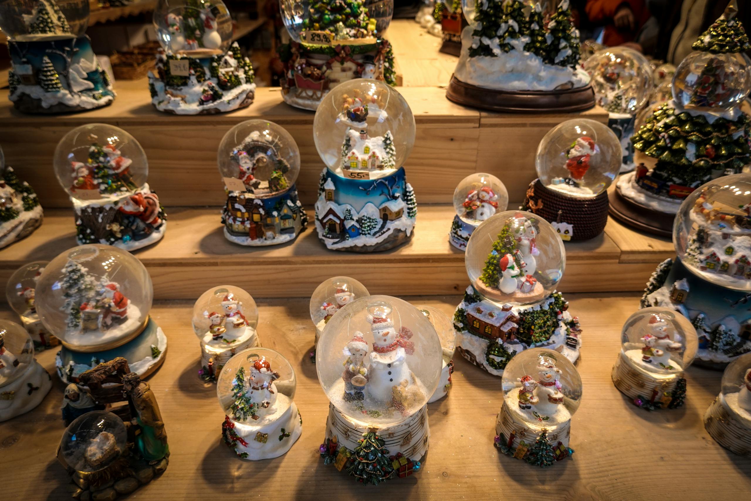 A collection of festive snow globes on display, perfect for holiday decorations and winter celebrations.