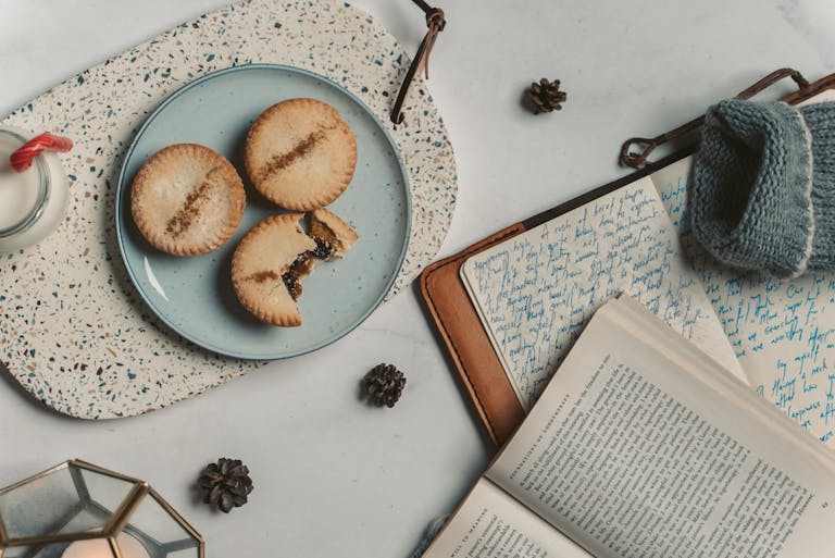 A cozy scene with cookies and journals, perfect for winter reading and relaxation.