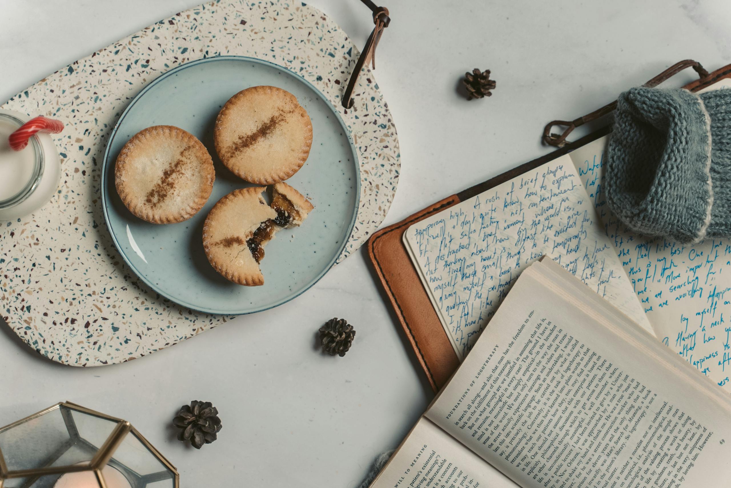 A cozy scene with cookies and journals, perfect for winter reading and relaxation.