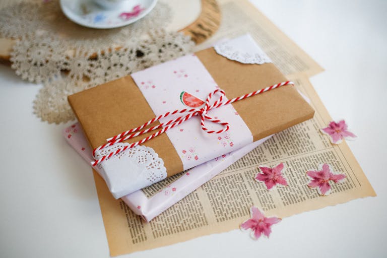 Charming gift wrapped with brown paper and pink floral accents, perfect for special occasions.