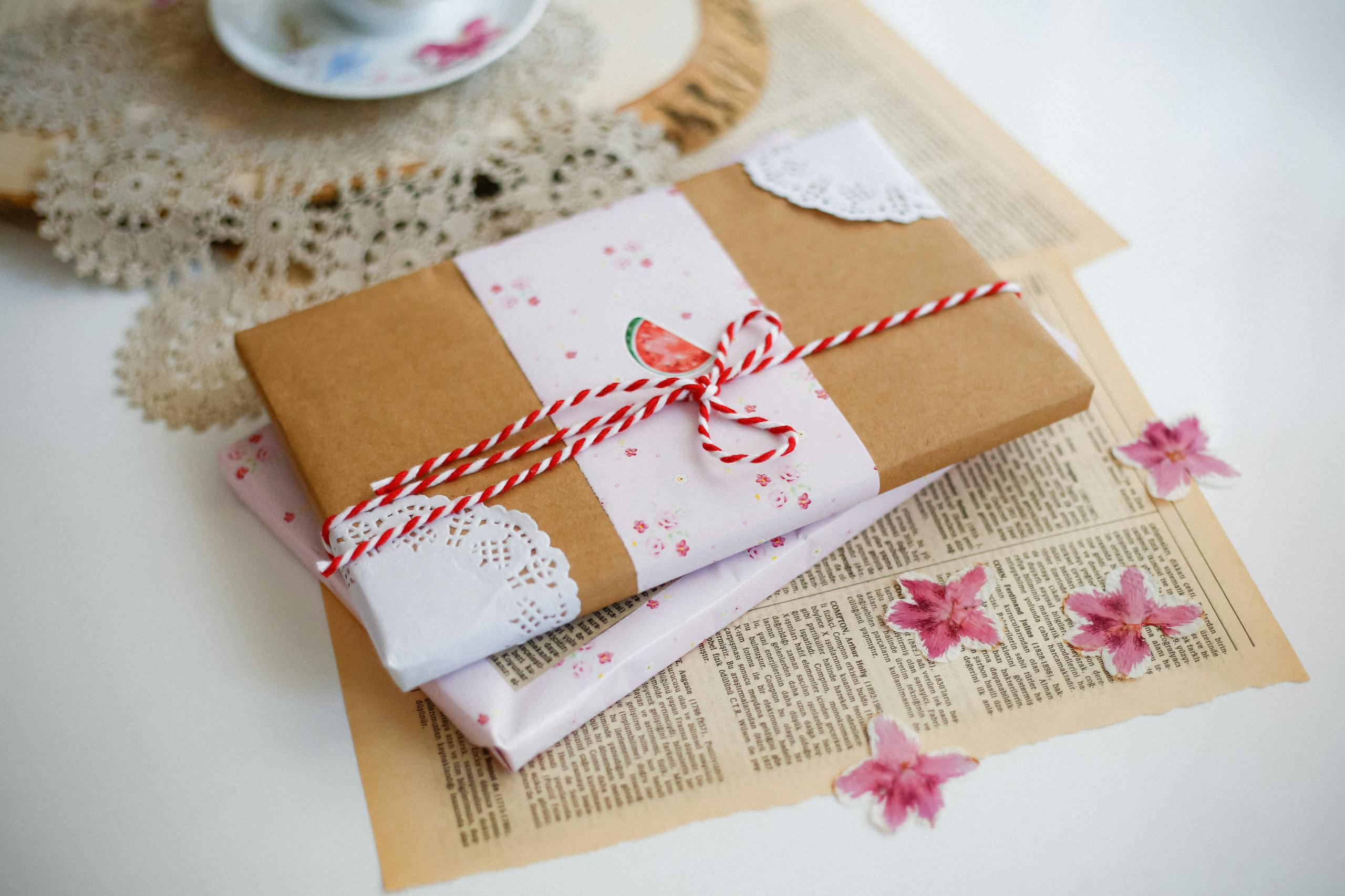 Charming gift wrapped with brown paper and pink floral accents, perfect for special occasions.